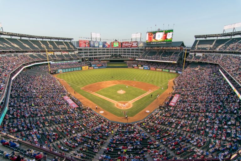 An aerial view of a baseball game in progress with a full stadium around the diamond