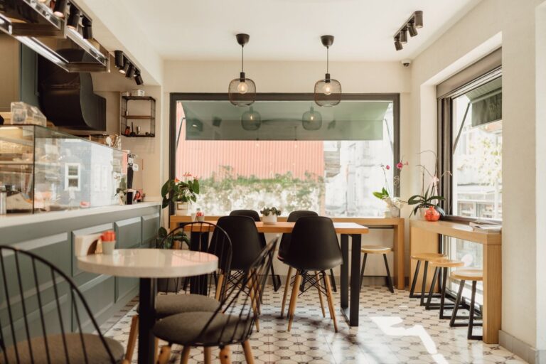 Bright modern restaurant dining room with a round table and chairs by a window