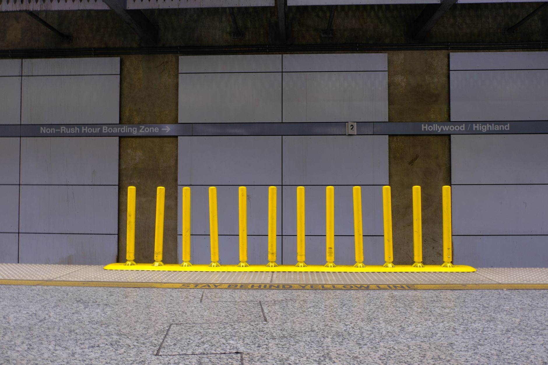 Yellow safety barrier posts along the platform edge at a metro station